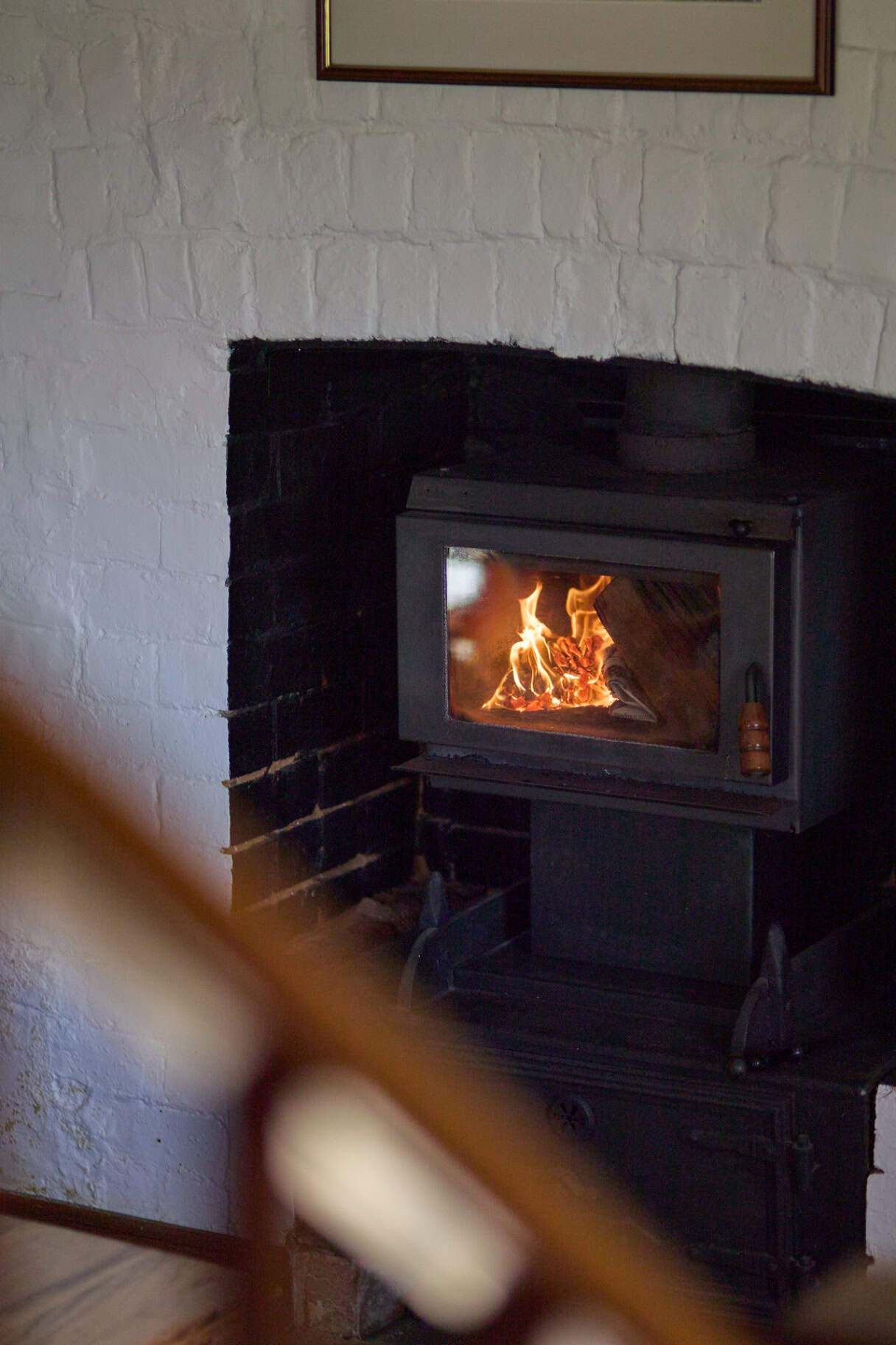 Wood heater in convict-brick fireplace